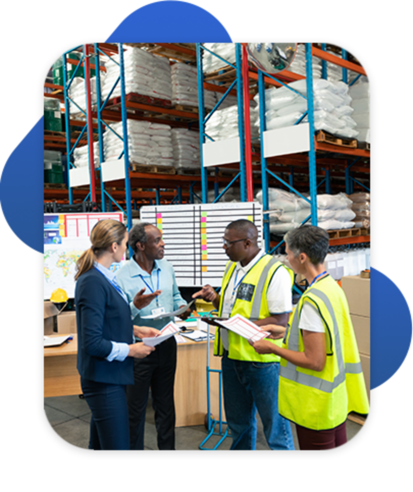 Group of distribution employees discussing warehouse strategy