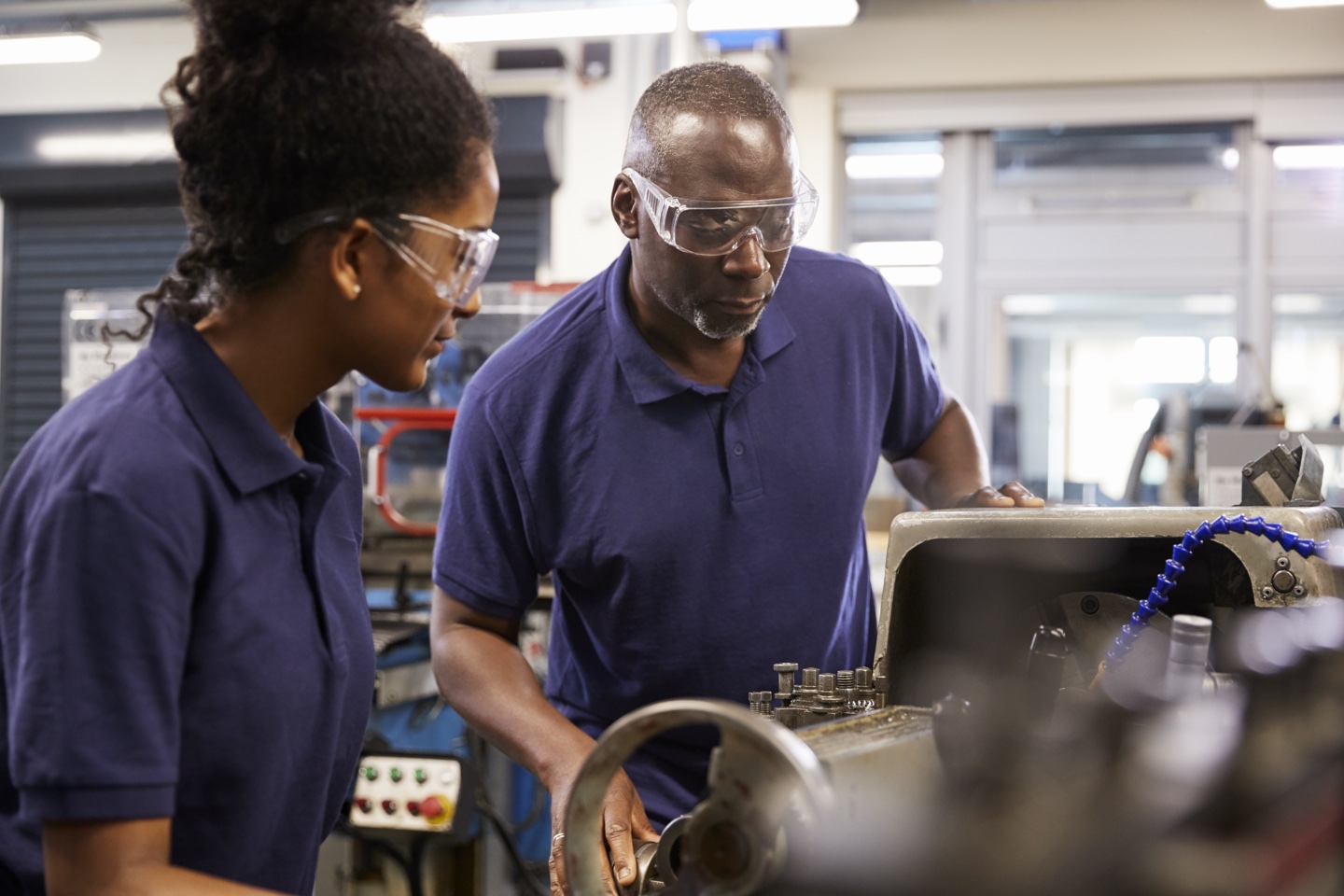 Manufacturing workers using equipment