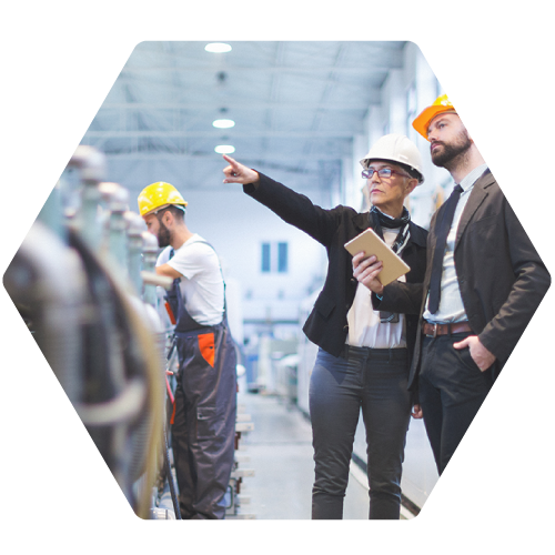 two managers in hard hats on factory floor